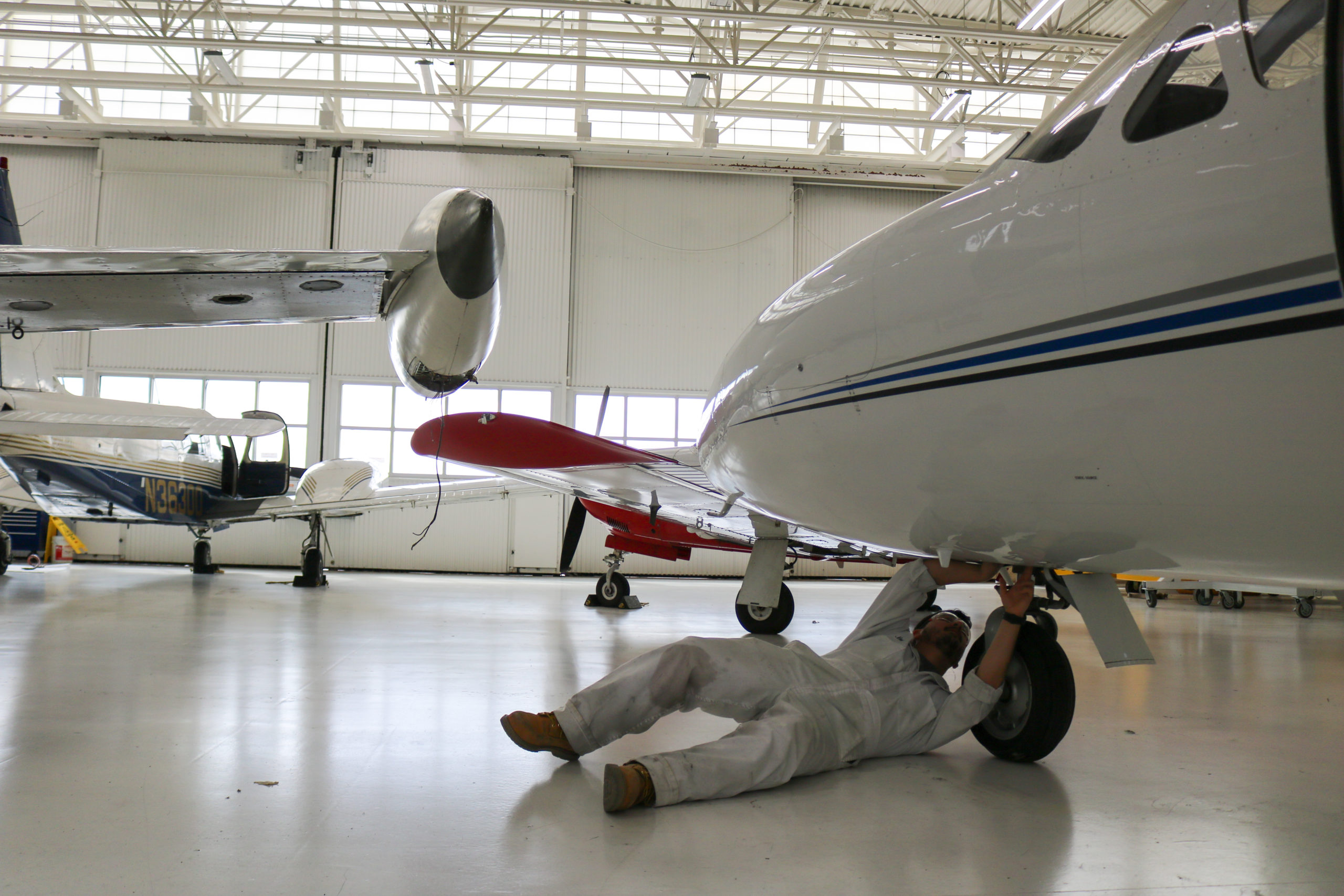 CT Aero student fixing parts under plane