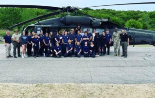 Vinal Tech Criminal Justice students pose in front of US Army helicopter