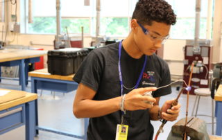 HVAC student working in the shop