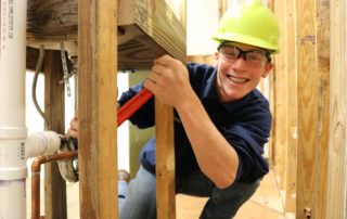 Plumbing and Heating student smiles for camera as he practices his skills