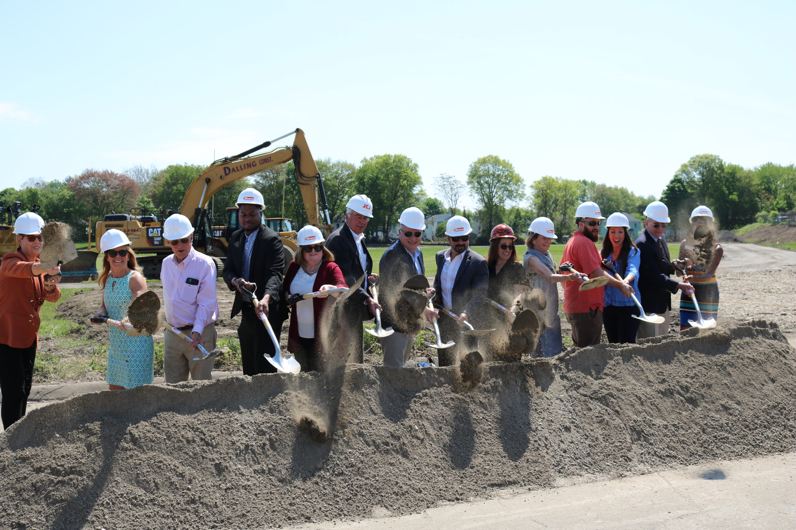 Local and state officials stand in front of a dirt pile holding shovels during the Bullard-Havens groundbreaking ceremony.