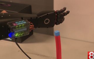 Robotic arm places block at W.F. Kaynor Technical High School